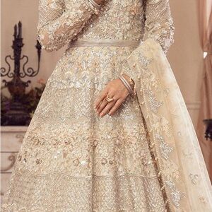Elegant Cream Gown with Long Bishop Sleeves and Embellished Tiered Design